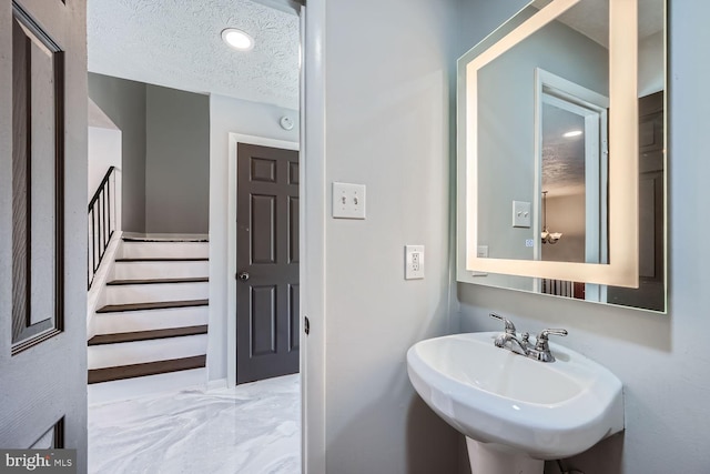 bathroom with sink and a textured ceiling