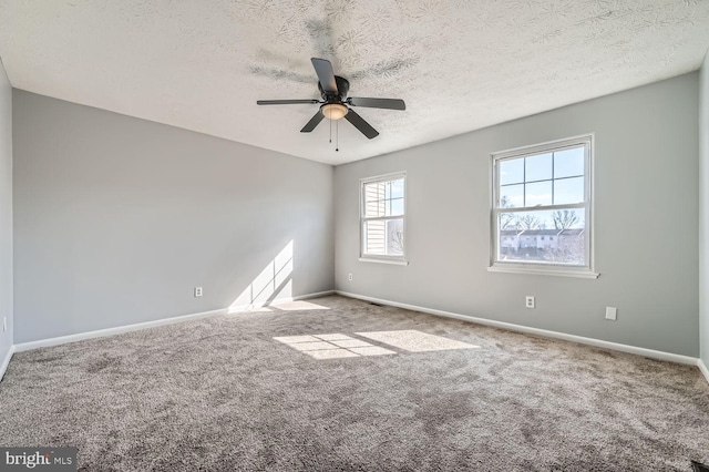 carpeted spare room with ceiling fan and a textured ceiling