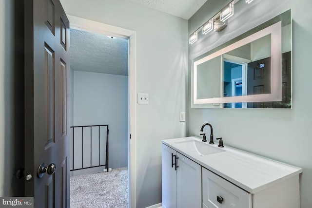 bathroom with vanity and a textured ceiling