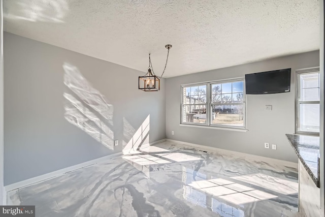 unfurnished dining area featuring a textured ceiling