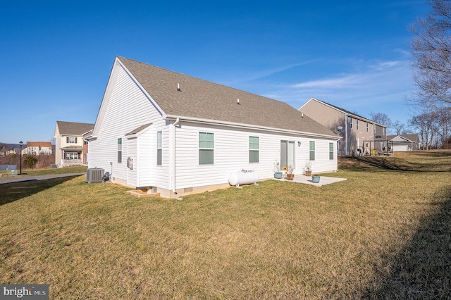 rear view of property with a yard, central AC unit, and a patio