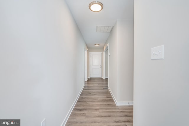 corridor with light wood-type flooring