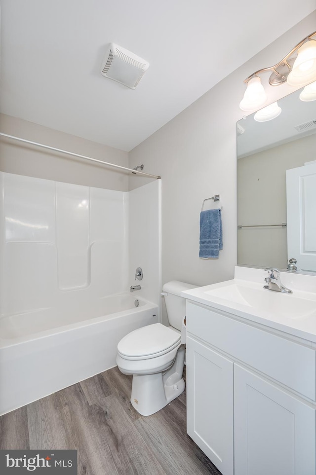 full bathroom with toilet, vanity, shower / bathtub combination, and hardwood / wood-style floors