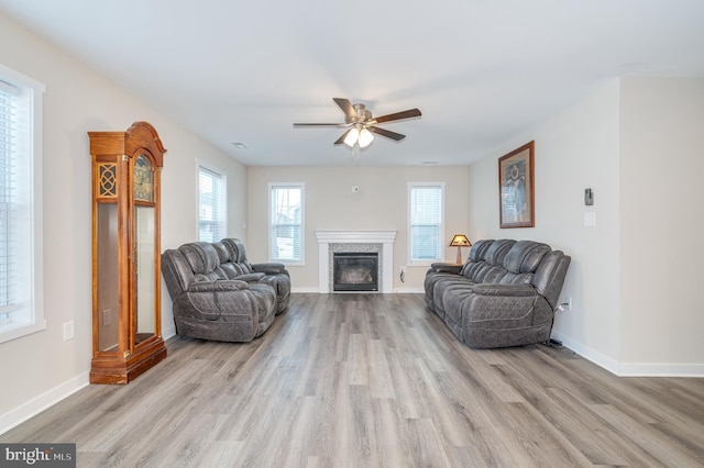 living room featuring ceiling fan and light hardwood / wood-style flooring