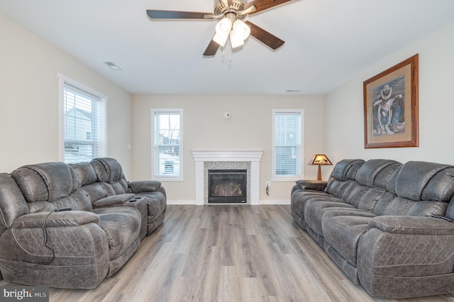 living room featuring ceiling fan and light hardwood / wood-style floors