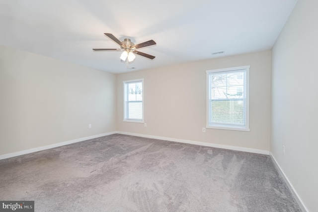 unfurnished room featuring ceiling fan and carpet floors