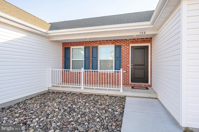 view of exterior entry featuring a porch