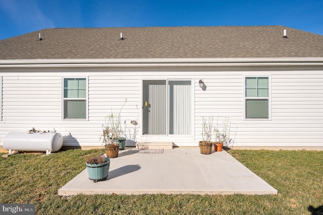 rear view of property with a lawn and a patio area