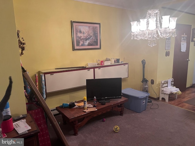 carpeted home office with ornamental molding and a notable chandelier