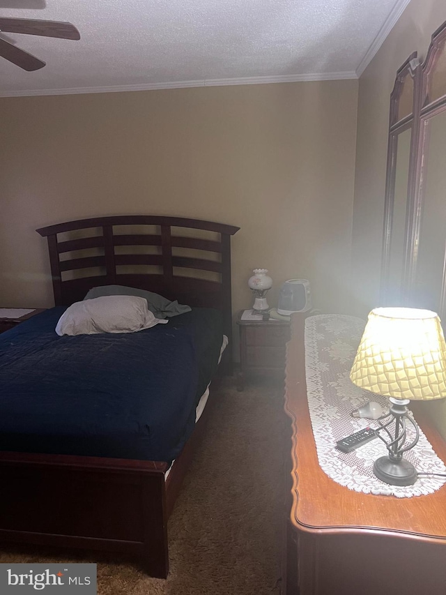 carpeted bedroom featuring ceiling fan, ornamental molding, and a textured ceiling