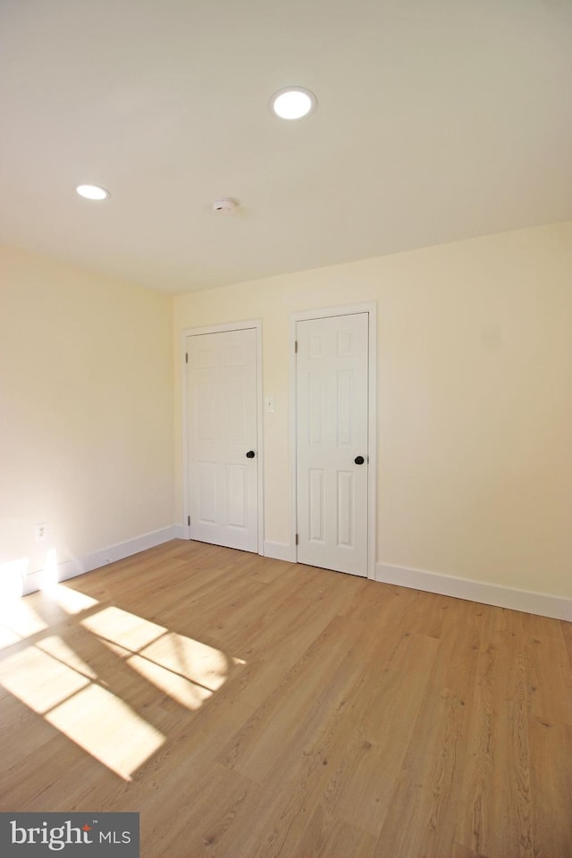 spare room with light hardwood / wood-style floors