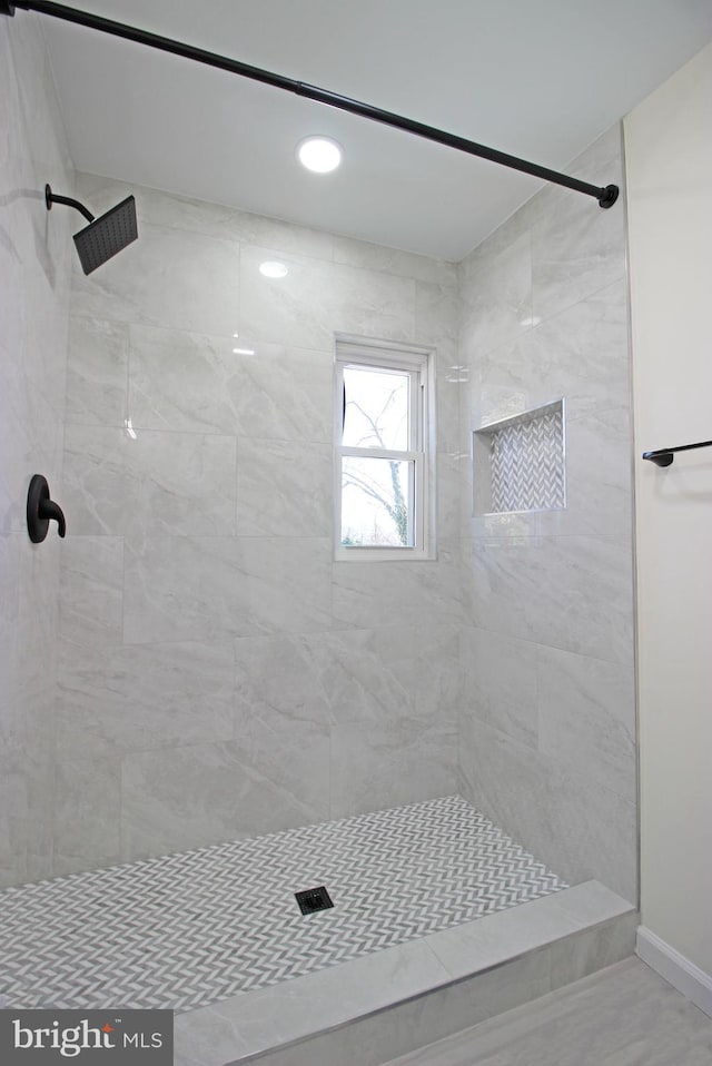 bathroom with a tile shower