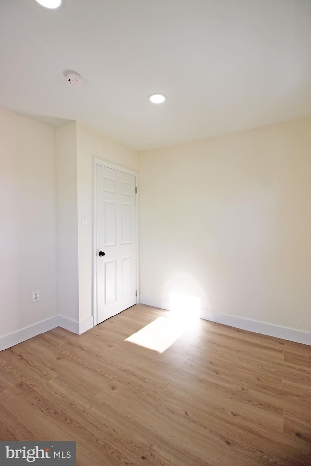 spare room with hardwood / wood-style floors