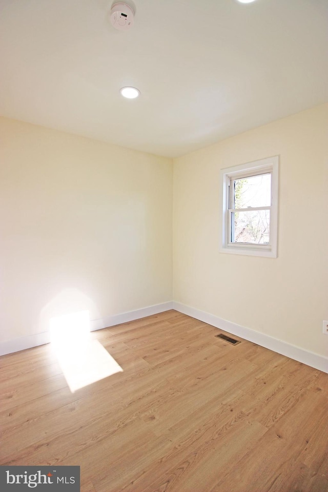 empty room with light hardwood / wood-style floors