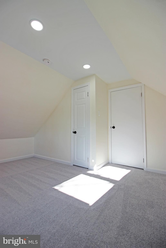 bonus room featuring light carpet and lofted ceiling