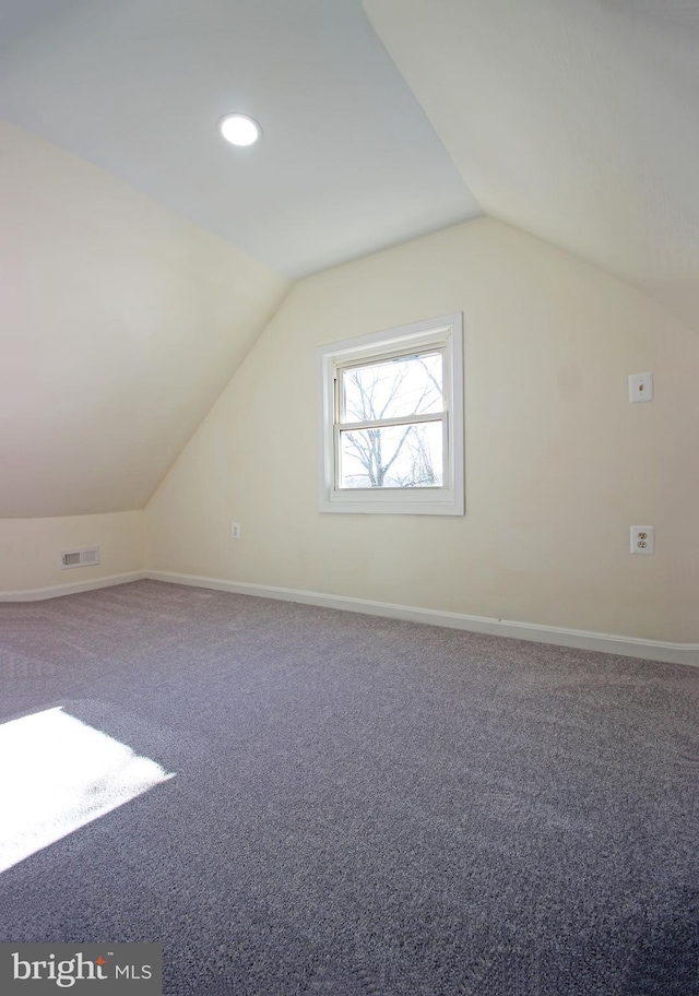 bonus room with carpet floors and lofted ceiling