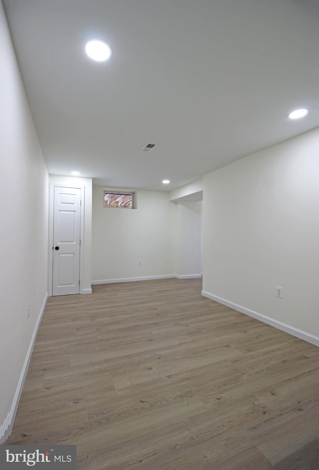 basement with light hardwood / wood-style floors