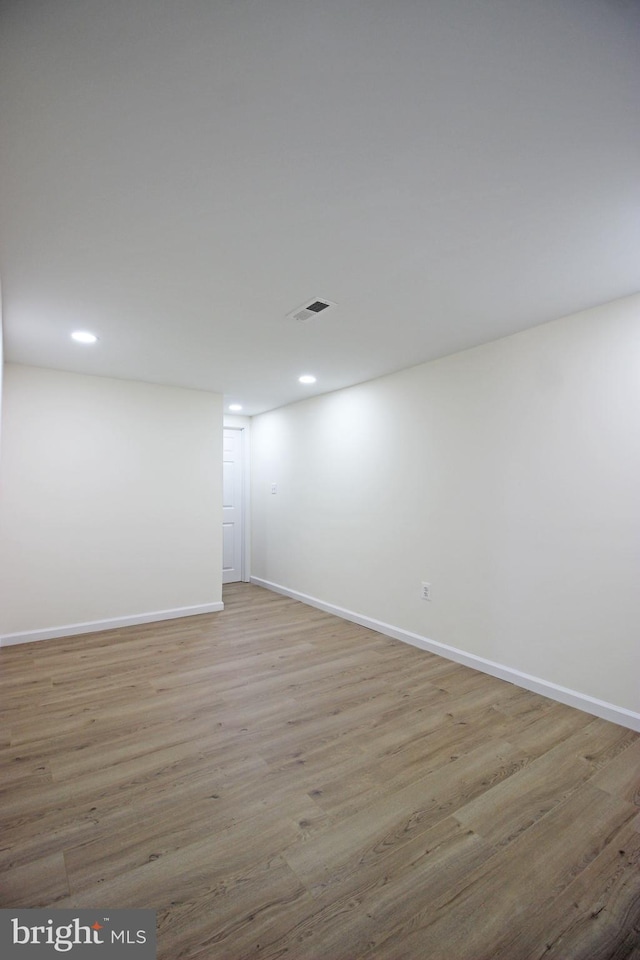 basement with light hardwood / wood-style flooring