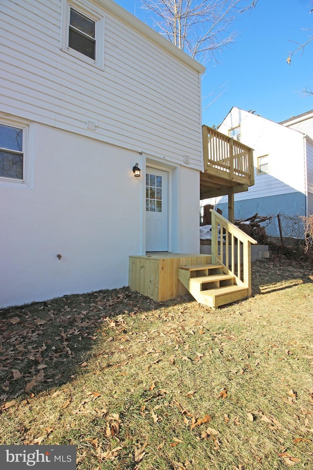 back of house featuring a wooden deck