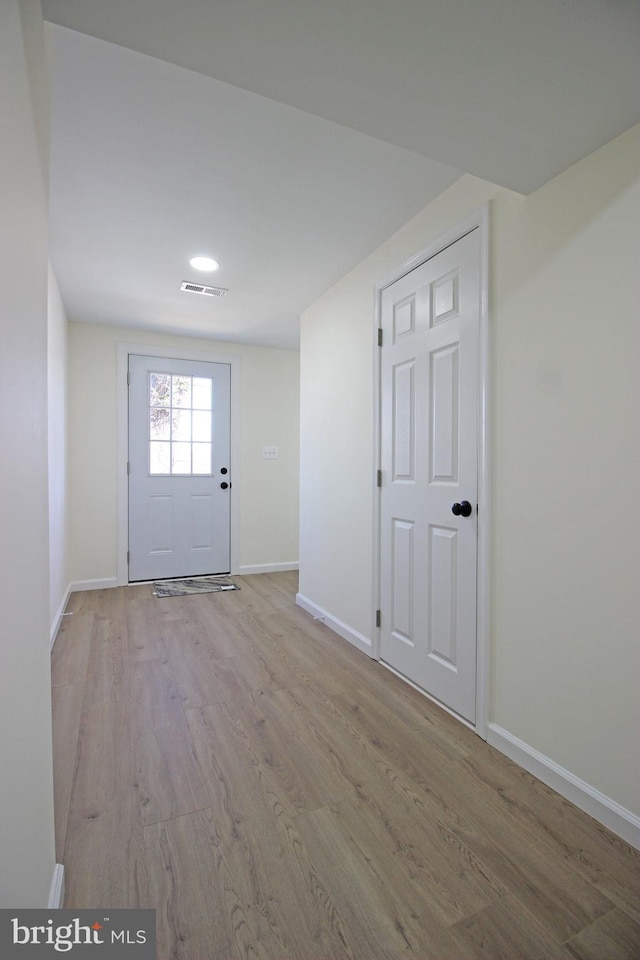 doorway to outside with light wood-type flooring