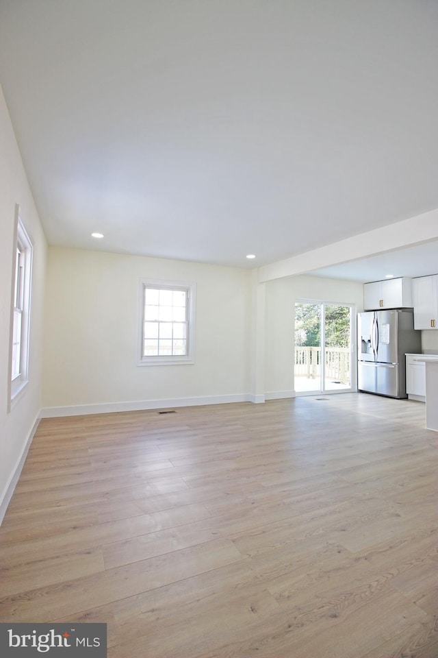 spare room featuring light hardwood / wood-style flooring