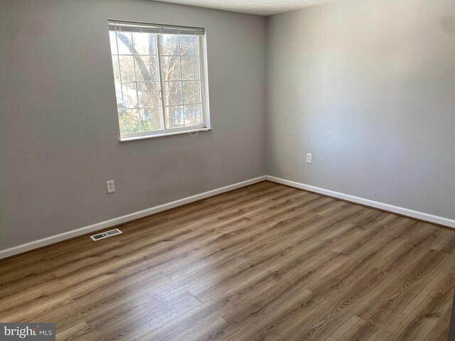 unfurnished room featuring wood-type flooring