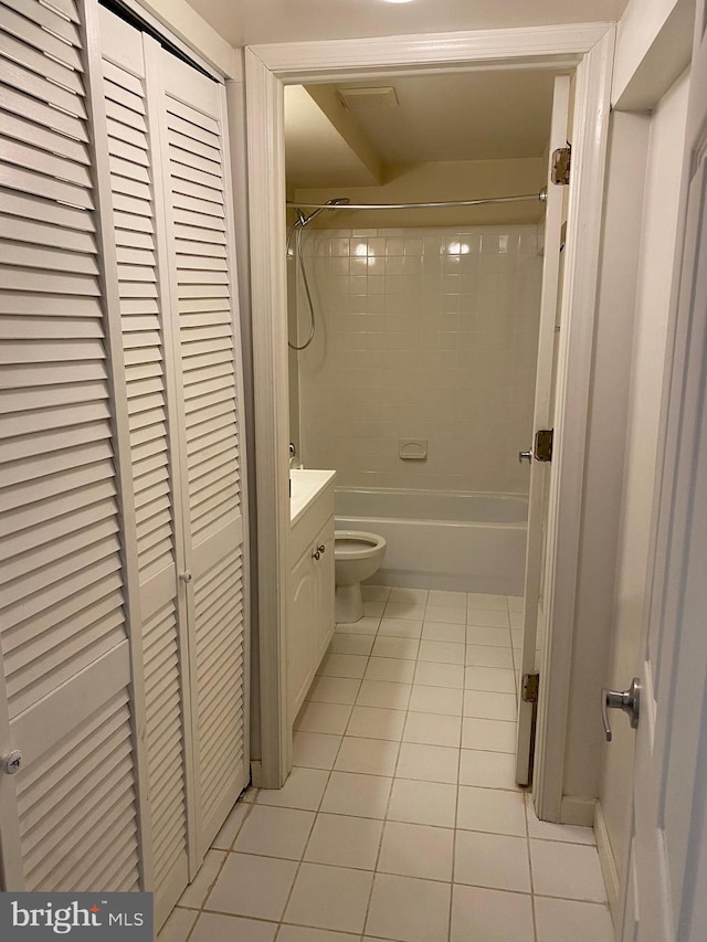 full bathroom with toilet, vanity, tile patterned flooring, and tiled shower / bath