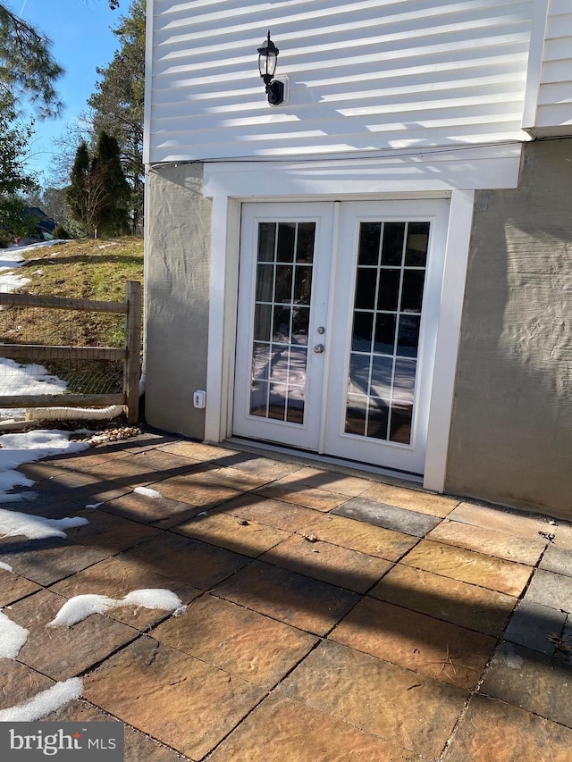 entrance to property featuring french doors and a patio