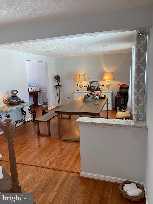 interior space with wood-type flooring and a textured ceiling