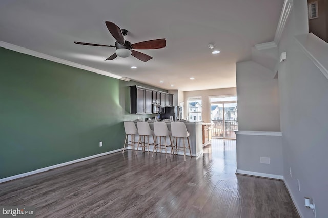 living room featuring ceiling fan, dark hardwood / wood-style flooring, and ornamental molding