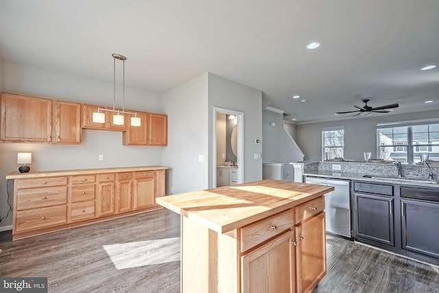 kitchen with dishwasher, wood-type flooring, sink, hanging light fixtures, and butcher block counters