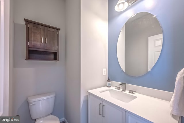 bathroom featuring toilet and vanity