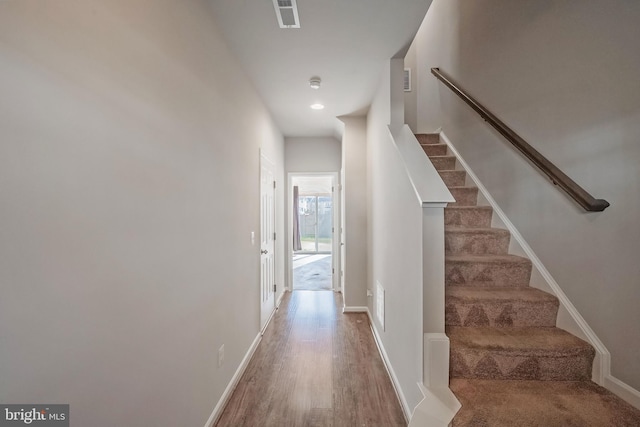 stairs with wood-type flooring