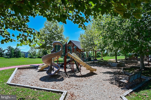 view of playground with a lawn