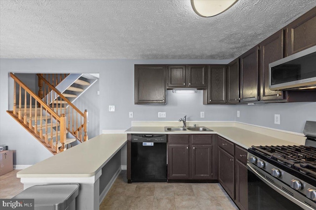 kitchen featuring sink, kitchen peninsula, dark brown cabinetry, and stainless steel appliances