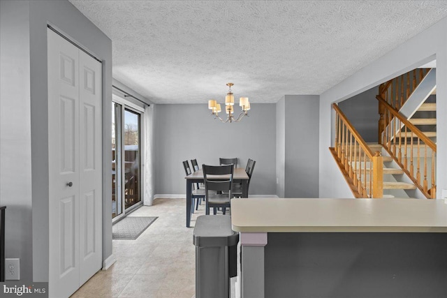 dining area featuring a textured ceiling and an inviting chandelier