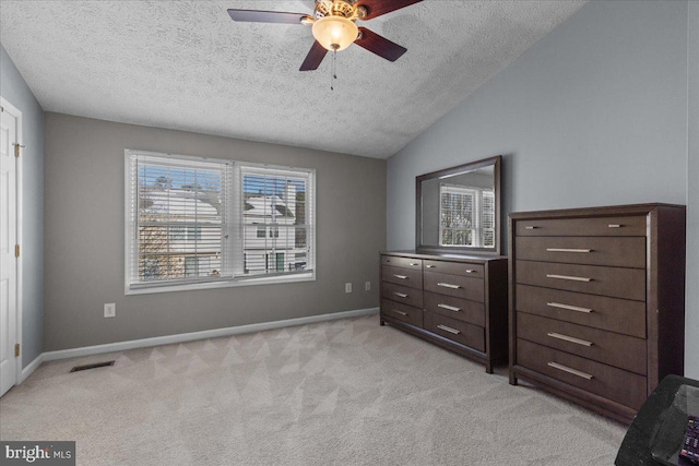 unfurnished bedroom featuring a textured ceiling, ceiling fan, lofted ceiling, and light colored carpet