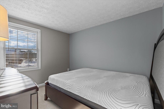 carpeted bedroom with a textured ceiling