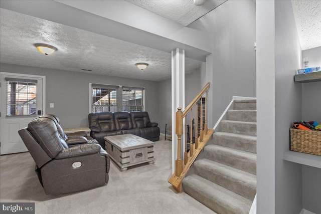 living room with a textured ceiling, light carpet, and a healthy amount of sunlight