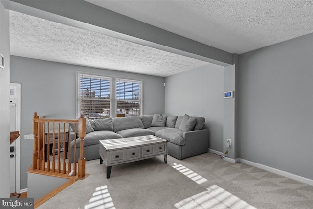 carpeted living room featuring a textured ceiling