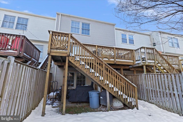 snow covered property featuring a wooden deck