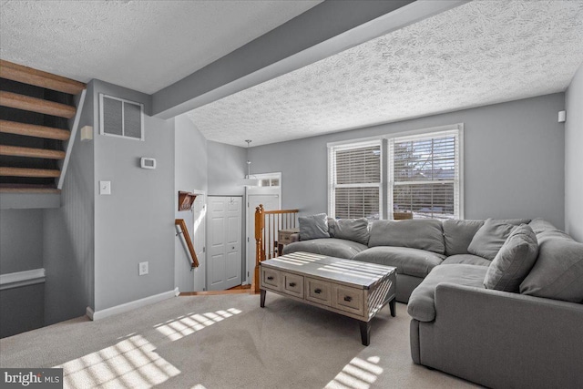 living room featuring light carpet and a textured ceiling