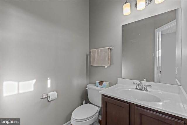 bathroom featuring toilet and vanity