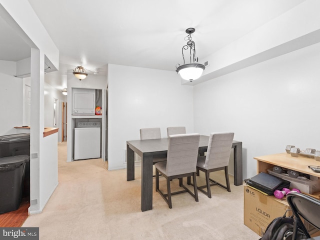 carpeted dining space featuring washer / dryer