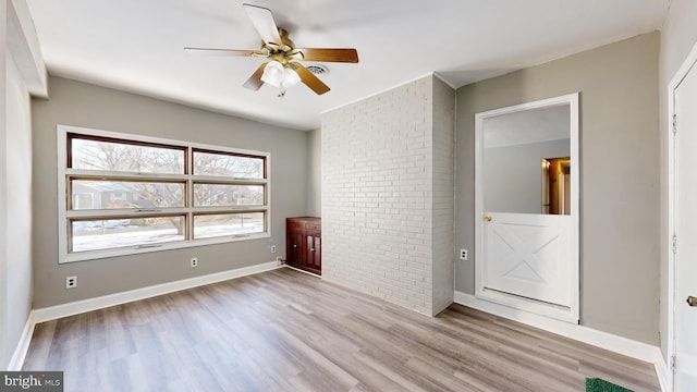 unfurnished bedroom featuring ceiling fan, ensuite bath, and light hardwood / wood-style flooring