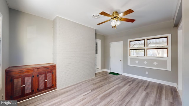 unfurnished room with light wood-type flooring and ceiling fan