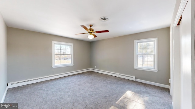 carpeted empty room with ceiling fan and a baseboard radiator