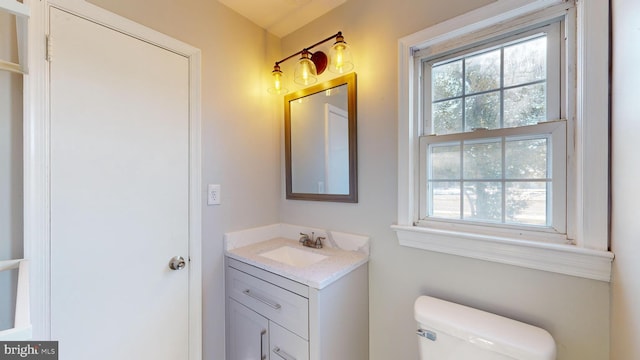 bathroom featuring toilet and vanity