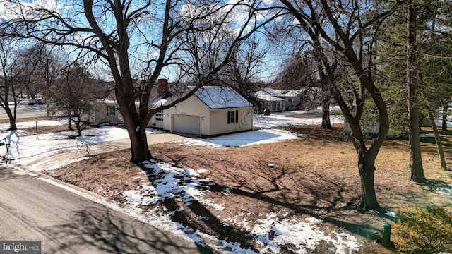 snow covered property featuring a garage