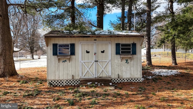 view of shed featuring fence